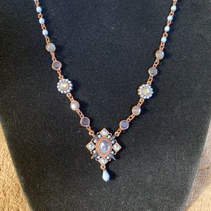 Beautiful blue and gold dangle necklace.